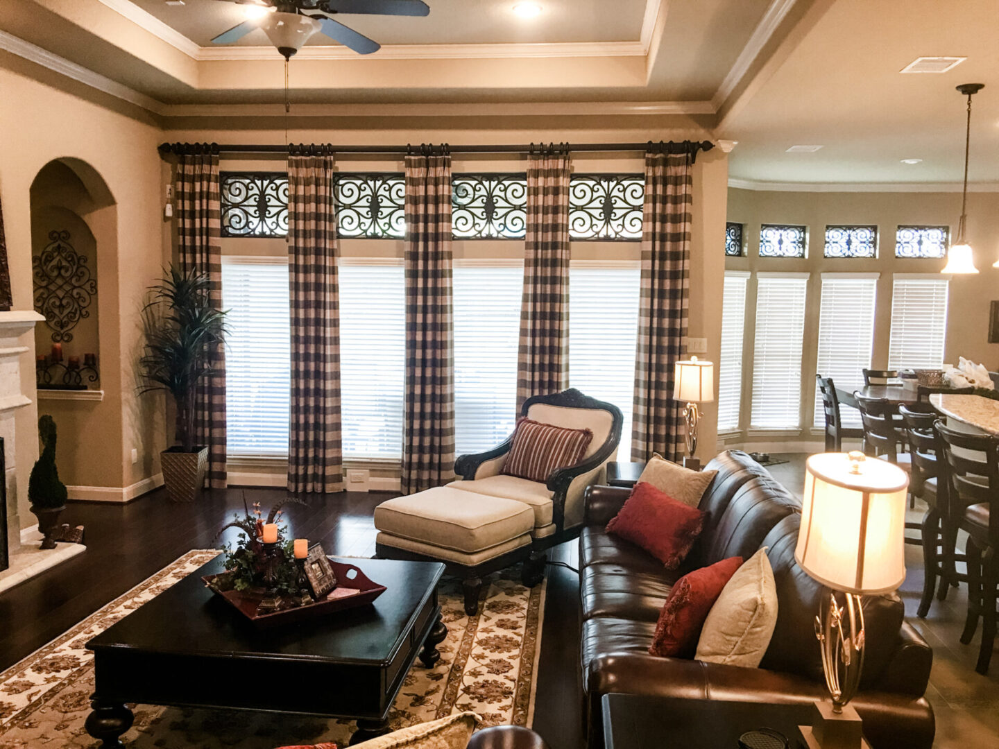 A living room with couches, chairs and tables.